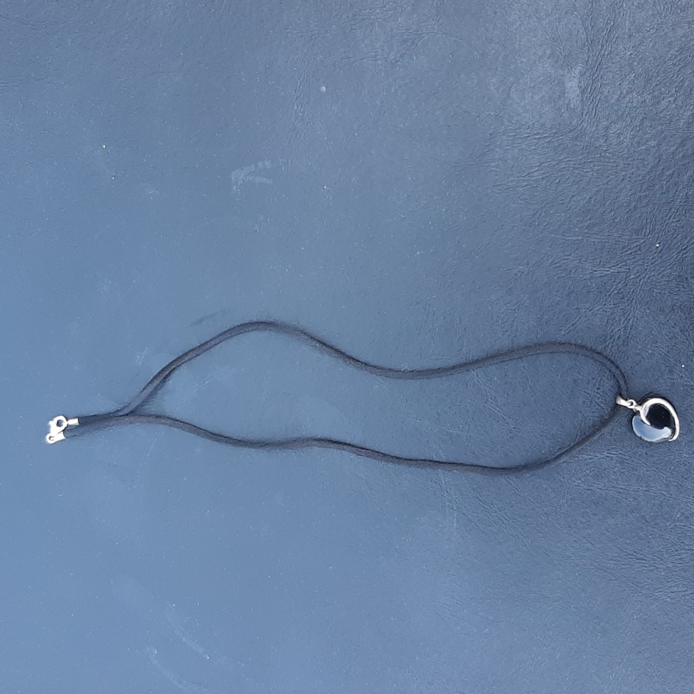 Black heart pendant on black lanyard. New.